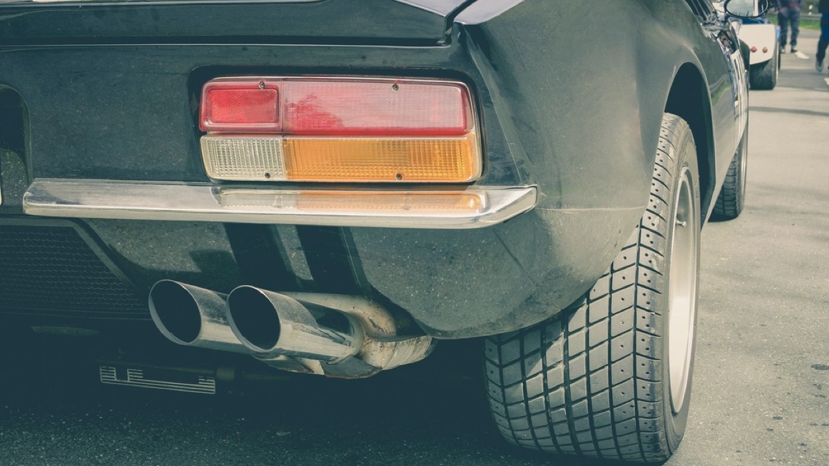 The rear of a car showing twin polished exhaust tips beneath the bumper.